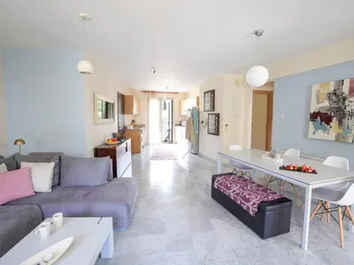 a living room with a couch and a table at Mediterranean Escape - Coastal 2-Bedroom Apartment Limassol in Limassol