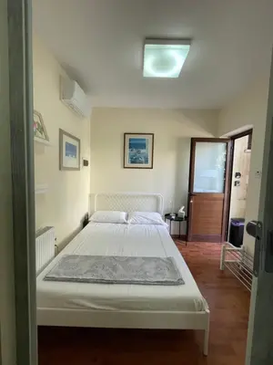 a bedroom with a white bed in a room at Yard room with private entrance in Larnaka