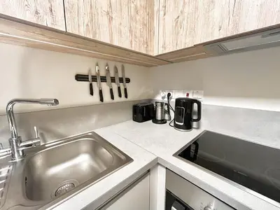 a kitchen with a sink and a counter top at STAY Mythical Blue Apartment in Protaras