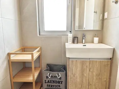 a bathroom with a sink and a mirror at STAY Mythical Blue Apartment in Protaras