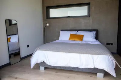 a bedroom with a large bed with an orange pillow at Mi Filoxenia 2 in Aglantzia