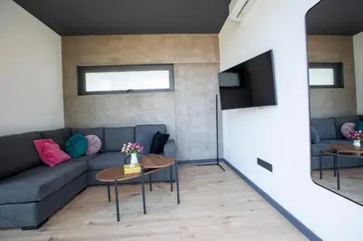 a living room with a couch and a tv at Mi Filoxenia 2 in Aglantzia