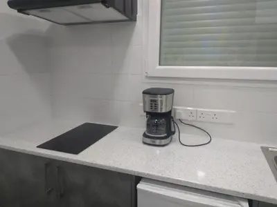 a coffee maker sitting on a counter in a kitchen at Ermioni Apartments in Limassol