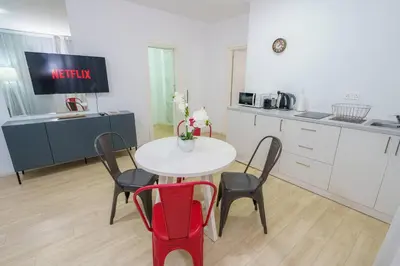 a kitchen with a table and chairs in a room at Kitieos 163 Suite in Finikoudes in Larnaka
