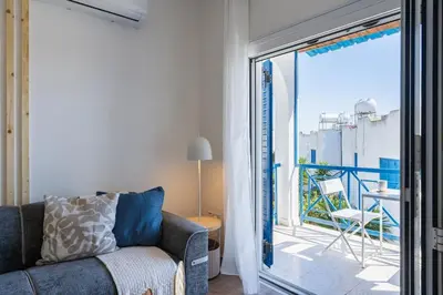 a living room with a couch and a balcony at Seacret - 1-BR Apartment & Pool in Pyla in Pyla