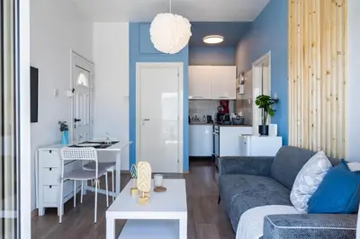 a living room with a couch and a kitchen at Seacret - 1-BR Apartment & Pool in Pyla in Pyla