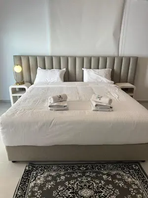a bedroom with a bed with two towels on it at 204 Lux Suites Level2 Tower 206 in Nicosia