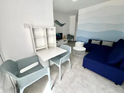 a living room with a blue couch and a blue chair at STAY Napa Ocean Apartment in Ayia Napa