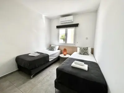a small room with two beds and a window at STAY Napa Ocean Apartment in Ayia Napa