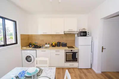a kitchen with white cabinets and a white refrigerator at Cozy Apartment in Kapparis #80 in Paralimni