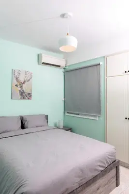 a bedroom with a bed and a blue wall at Azura 3 Bedroom Apartment in Larnaka