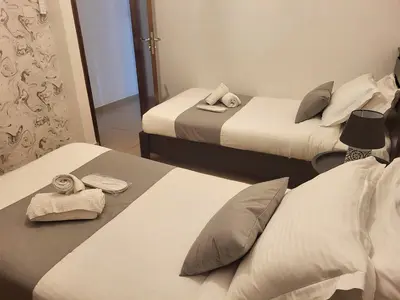 a hotel room with two beds with towels on them at Sunshine Escape in Larnaka