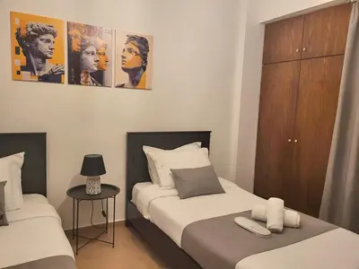 a bedroom with two beds and a night stand at Sunshine Escape in Larnaka