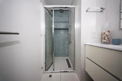 a shower with a glass door in a bathroom at Sunset Family Villa w heated pool - 1Min Walk to Beach in Protaras