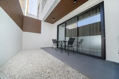 a room with a table and chairs and a large window at Luxury Studio in the Heart of Limassol in Limassol