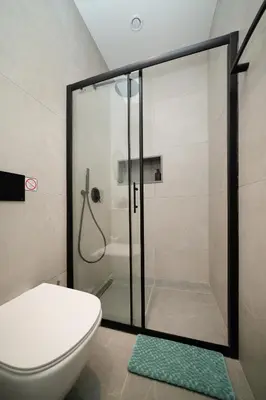 a bathroom with a glass shower with a toilet at Luxury Studio in the Heart of Limassol in Limassol