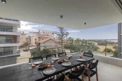 a dining room with a table and a large window at Mackenzy Dream Residence 202 in Larnaka