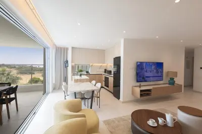 a living room with a kitchen and a dining room at Mackenzy Dream Residence 202 in Larnaka