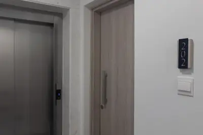a door in a room with a clock on the wall at Mackenzy Dream Residence 202 in Larnaka