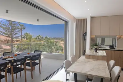 a dining room and kitchen with a large window at Mackenzy Dream Residence 202 in Larnaka