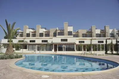 a large swimming pool in front of a building at Zavos Aqua Park Club Apt by TrulyCyprus in Limassol