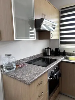 a kitchen with a sink and a stove top oven at Modern Holiday Appartment With Pool in Paralimni