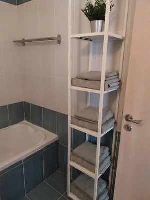 a towel rack in a bathroom with towels and a tub at Modern Holiday Appartment With Pool in Paralimni