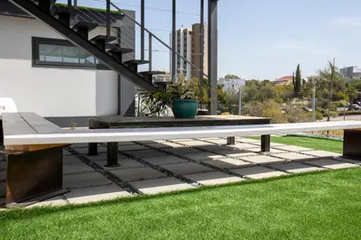 a picnic table on a patio with green grass at Mi Filoxenia 1 in Aglantzia