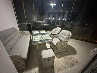 a living room with a table and a couch at Park Residence Premium in Larnaka