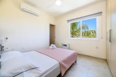 a bedroom with a bed and a window at Protaras Holiday Villa - Katia 8B in Protaras