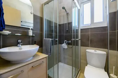 a bathroom with a shower and a sink and a toilet at Protaras Holiday Villa - Katia 8B in Protaras