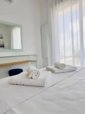 two towels are sitting on top of a bed at Nissini Wana Luxury Villa in Ayia Napa