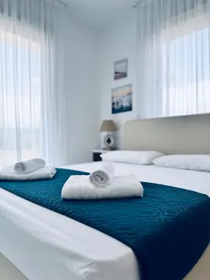 two beds in a bedroom with towels on them at Nissini Wana Luxury Villa in Ayia Napa