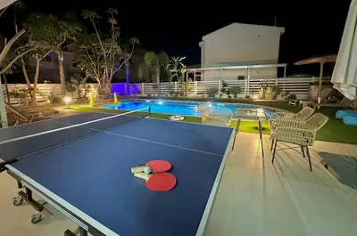 a ping pong table in front of a pool at Dream Tropicana Villa - Ayia Napa in Ayia Napa