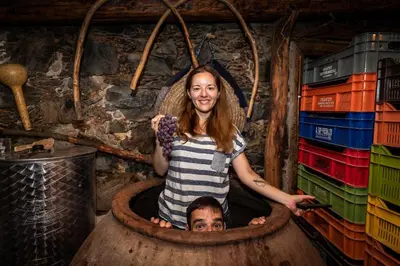 a woman and a child sitting in a barrel at Hatzikyprianou Museum Studio in Lazania