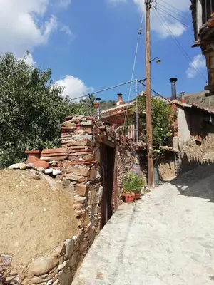 a stone wall next to a street at Hatzikyprianou Museum Studio in Lazania