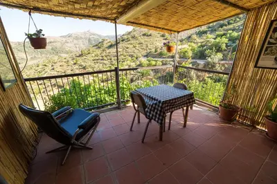 a patio with a table and chairs on a balcony at Hatzikyprianou Museum Studio in Lazania