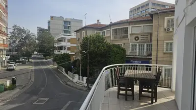 a balcony with a table and chairs on a city street at STAY Hydra Comfort Apartment in Nicosia
