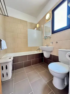 a bathroom with a toilet and a sink and a tub at Villa ILIOS Cozy 2BR with Pool in Paralimni