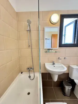a bathroom with a tub and a sink and a shower at Villa ILIOS Cozy 2BR with Pool in Paralimni