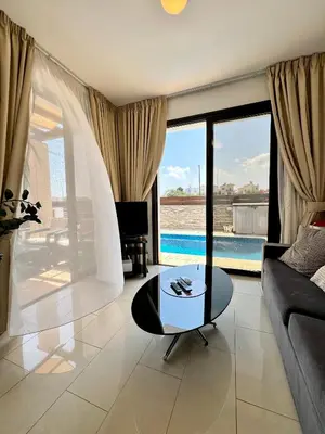 a living room with a couch and a table at Villa ILIOS Cozy 2BR with Pool in Paralimni