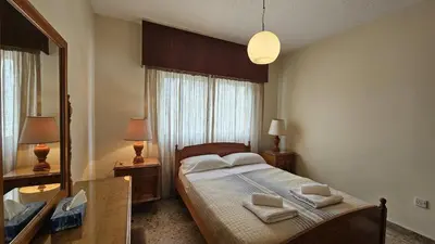 a bedroom with a bed and a large mirror at STAY Sea Gate Apartment in Larnaka
