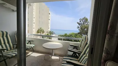 a balcony with chairs and a table and a view of the ocean at STAY Sea Gate Apartment in Larnaka