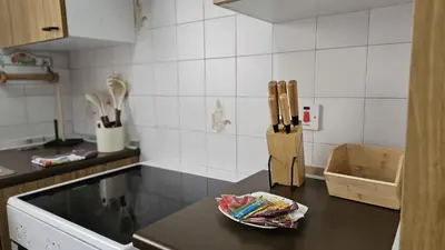 a kitchen counter with a knife block and a plate at STAY Sea Gate Apartment in Larnaka