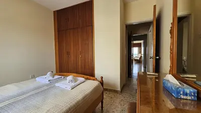 a bedroom with a bed with towels on it at STAY Sea Gate Apartment in Larnaka
