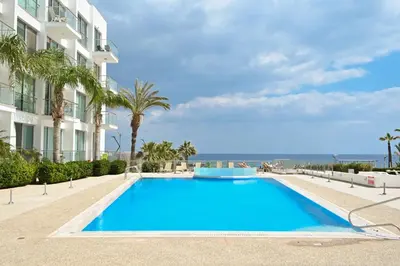 a large blue swimming pool next to a building at Crystal Coast in Protaras