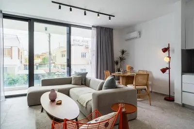 a living room with a couch and a table at Solara - Stylish Balcony Apartments in Larnaca in Larnaka