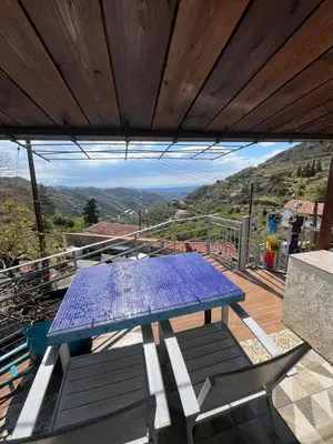 a blue picnic table on a deck with a view at Odou Residence in Odhou