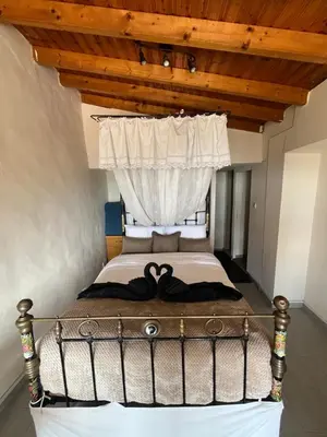 a bed in a room with a wooden ceiling at Odou Residence in Odhou