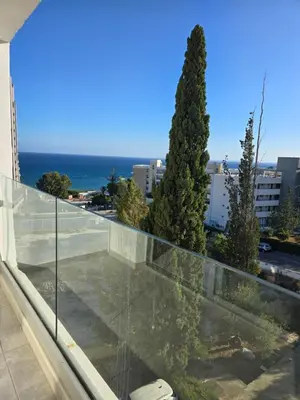 a view of the ocean from the balcony of a building at White Sea View Apartment in Limassol